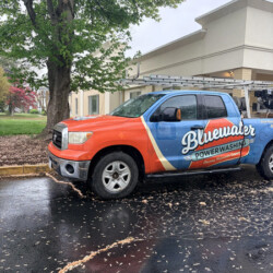 Bluewater Power Washing truck parked in a wet parking lot.