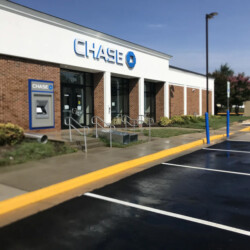 Exterior view of a Chase bank branch with an ATM and parking lot.