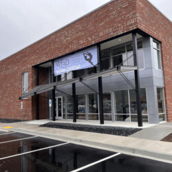 West End Academy of Dance building with a “Now Open” banner over the entrance.