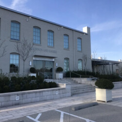 The McKinnon and Harris building exterior with a paved entrance and landscaping.